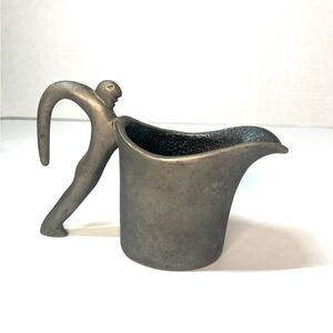 VINTAGE CARROL BOYES (1954 -
2019) MAN WAVE PEWTER MILK JUG
